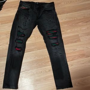 Black legacy edition ripped jeans. In the rips are a nice shade of red and green